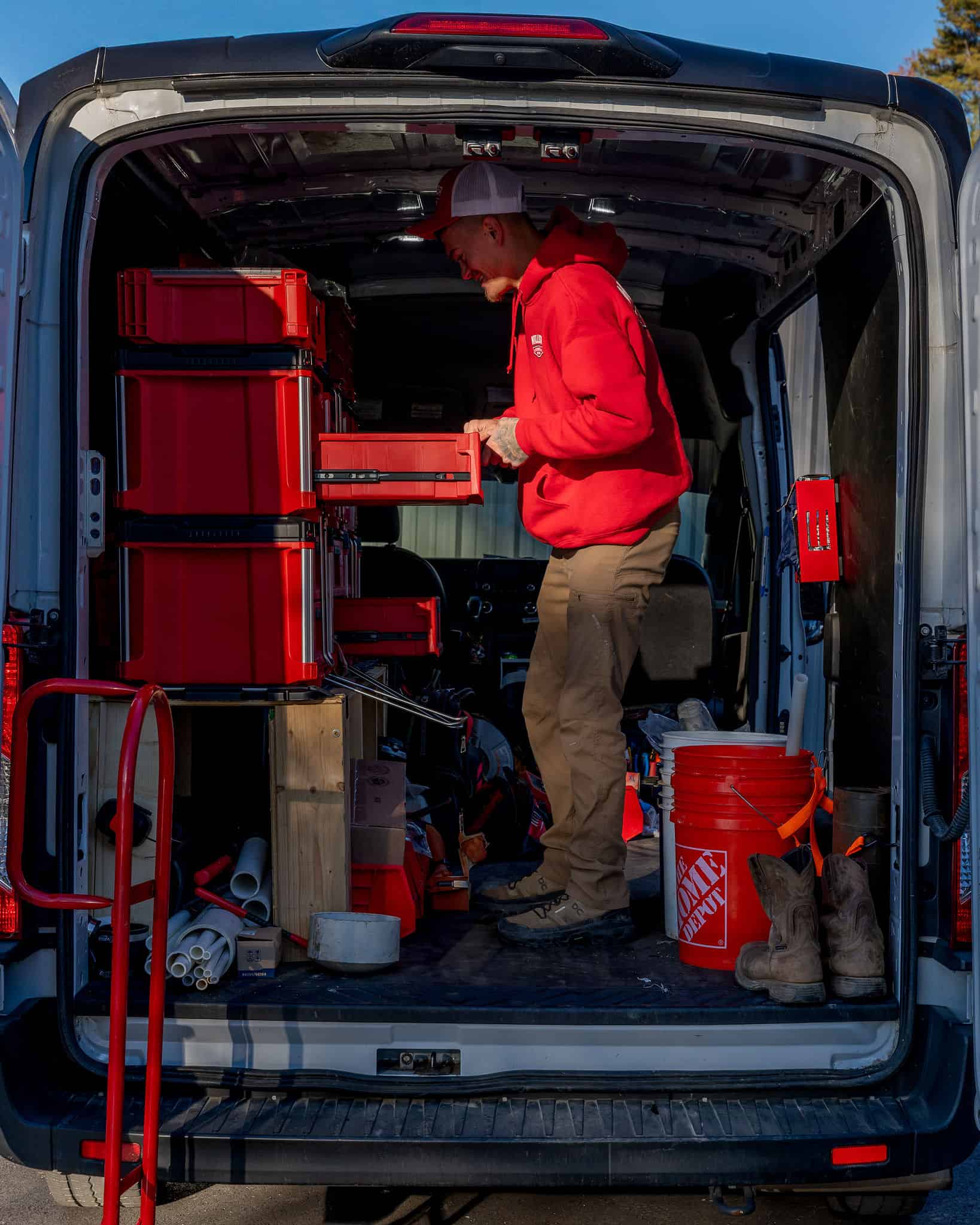 Looking into the back of a Miller Plumbing truck — bins and tools loaded and ready.